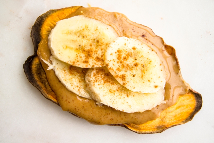 sweet potato toast topped with peanut butter almond butter, banana and cinnamon toppings
